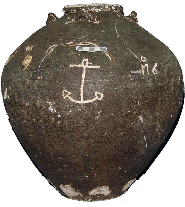 This is a grey-brown asian stoneware jar that has the image of an anchor inscribed on the side